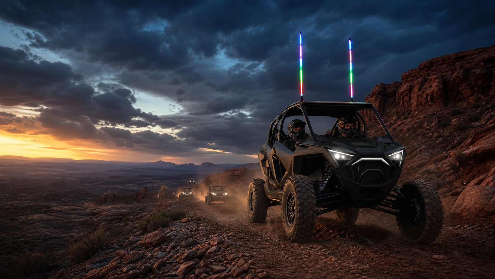 A convoy of off-road vehicles equipped with synchronized LED whips on a dramatic desert trail